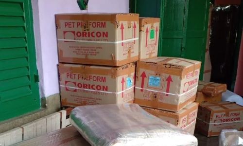•  Packers and movers wrapping wooden tables and shifting boxes in stretch film for safe transport.